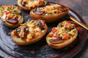 Tasty baked potato on plate, closeup
