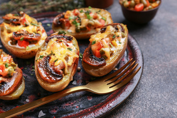 Plate with tasty baked potato on table, closeup