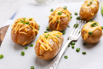 Tasty baked potato on parchment