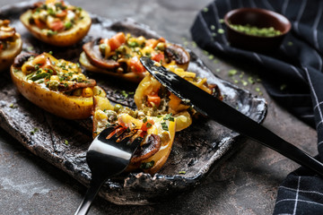 Plate with tasty baked potato on table