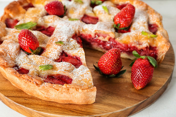 Tasty strawberry pie on wooden board