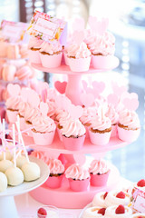 Delicious pink cupcakes on stander