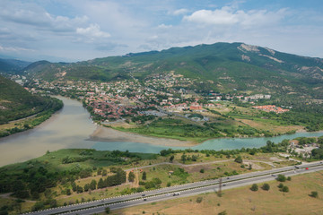 Naklejka premium Mtskheta, Georgia - Jul 07 2018: Holy city of Mtskheta view from Jvari Monastery in Mtskheta, Mtskheta-Mtianeti, Georgia. It is part of the World Heritage Site - Historical Monuments of Mtskheta.