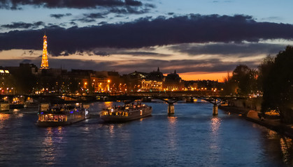 Fototapeta na wymiar Beautiful night Paris, sparkling tower, bridge over the River Seine and touristic boats. France