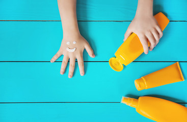 Sunscreen on the hand of a child. Selective focus.