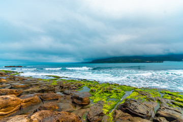 Beautiful seaside stone under the gloomy sky background. holiday concept. BEIJING, CHINA