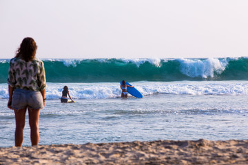 begginer surfers on waves