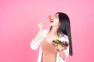 beauty woman Asian cute girl feel happy eating diet food fresh salad for good health on pink background - lifestyle beauty woman