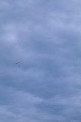 kite flying in the sky,flying, paraglider, parachute, paragliding, sport,clouds, extreme, adventure, air, flight,freedom, glider, gliding, cloud, skydiving,activity, wind,