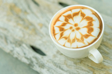 hot cappuccino coffee with nice pattern foam on table