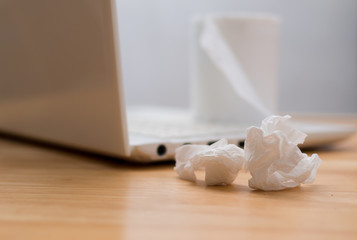 Fototapeta na wymiar Tissues papers on laptop, symbol of occupational disease or watching porn site