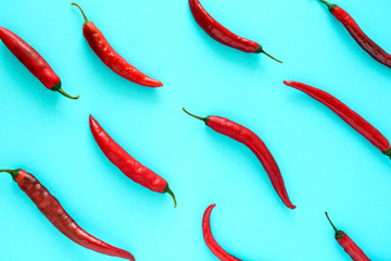 Red chili peppers pattern on blue background. Top view. Flat lay. Healthy eating or vegetarian concept