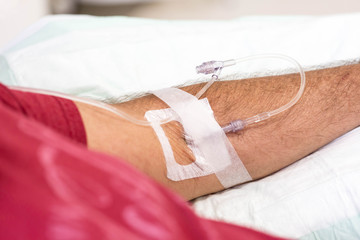Fototapeta premium man in hospital having an intravenous drip immunoglobulin infusion