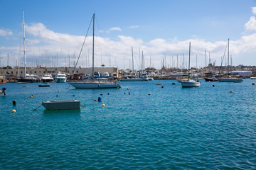 Fototapeta premium Panoramic view in Sliema, sailing boat and beautiful green waters of Mediterranean sea. Malta country. 