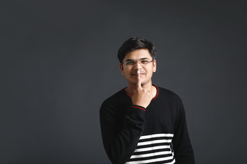 Indian young man showing direction with hand