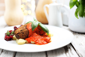 Pumpkin cutlets served with tomato sauce on dumplings on gnocchi, roasted beet salad.