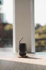 black beverage drink made from charcoal and milk on vintage style wood table