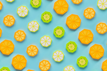 Fruit made of paper. Blue background. There's room for writing. Tropics. Flat lay. Orange, lemon.