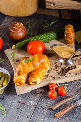 pies, loaf bread, dough on a wooden vintage cutting board old rustic, mustard sauce-dish, tomato,...