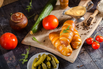 pies, loaf bread, dough on a wooden vintage cutting board old rustic, mustard sauce-dish, tomato,...