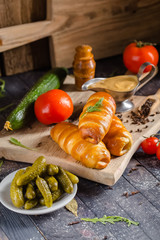 pies, loaf bread, dough on a wooden vintage cutting board old rustic, mustard sauce-dish, tomato,...