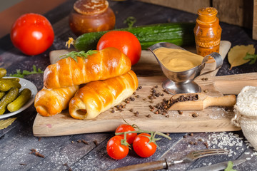 pies, loaf bread, dough on a wooden vintage cutting board old rustic, mustard sauce-dish, tomato,...
