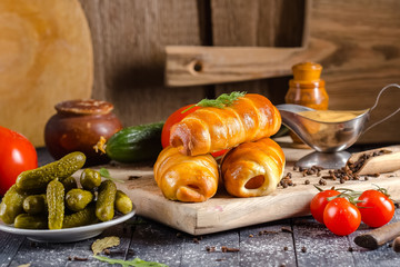 pies, loaf bread, dough on a wooden vintage cutting board old rustic, mustard sauce-dish, tomato,...