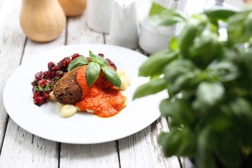 Cauliflower cutlets served with roasted peppers sauce on dumplings on gnocchi, roasted beetroot salad.