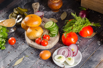 pies, loaf bread, dough on a wooden vintage cutting board old rustic, mustard sauce-dish, tomato,...