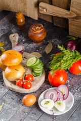 pies, loaf bread, dough on a wooden vintage cutting board old rustic, mustard sauce-dish, tomato,...
