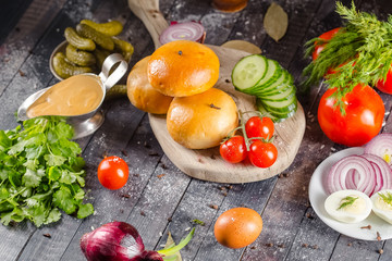 pies, loaf bread, dough on a wooden vintage cutting board old rustic, mustard sauce-dish, tomato,...