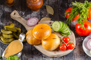 pies, loaf bread, dough on a wooden vintage cutting board old rustic, mustard sauce-dish, tomato,...
