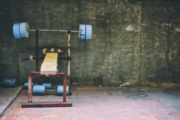 Homemade Barbell Bench in Concrete Room Background.