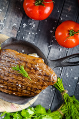 grilled kebab grilled meat steak lies in an iron frying pan, on a wooden vintage old board rustic,...