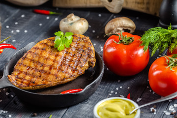 grilled kebab grilled meat steak lies in an iron frying pan, on a wooden vintage old board rustic,...