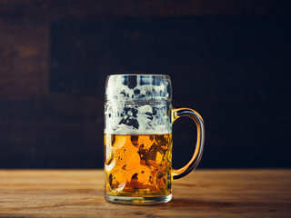 Glass of beer on wooden table