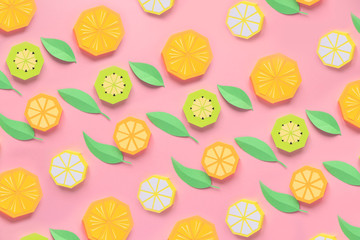 Fruit made of paper. Pink background. There's room for writing. Tropics. Flat lay. Orange, lemon.