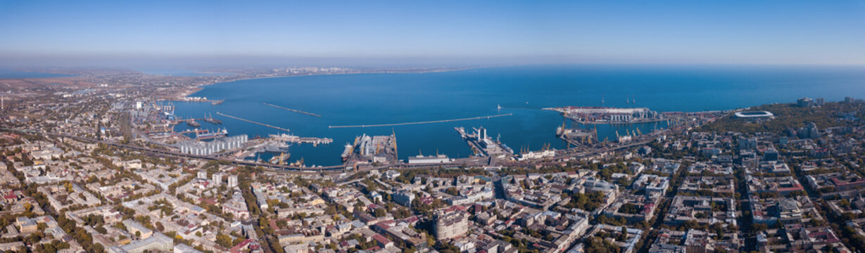 Panorama of the city of Odessa and the sea with a port against a blue sky on a sunny day. Aerial view from the drone