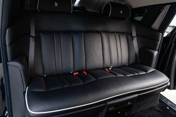  Interior view of new a very expensive car, a long black limousine with rear seats for important person on parking