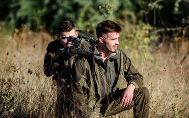 Teamwork and support. Activity for real men concept. Hunters with rifles in nature environment....