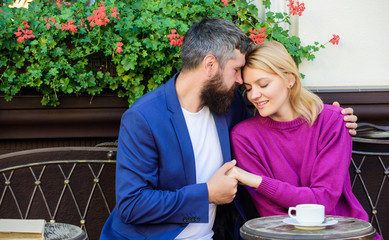 Life together. woman and man with beard relax in cafe. Brutal bearded hipster and girl drink coffee. Morning coffee. Couple in love on. First meet of girl and mature man. Doing everything together