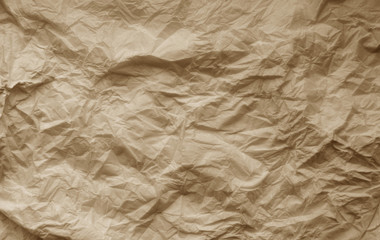 Crumpled sheet of paper in brown color.