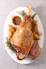 baked lamb leg with potato and sauce