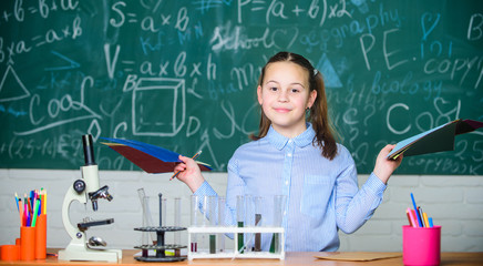 Chemical analysis. Laboratory glassware. School laboratory. Girl smart student conduct school experiment. School pupil study chemical liquids. School chemistry lesson. Test tubes with substances