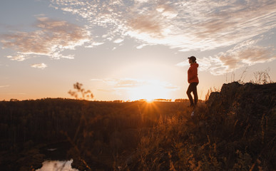 Silhouette of free woman enjoying freedom feeling happy at sunset. Serene relaxing woman in pure happiness