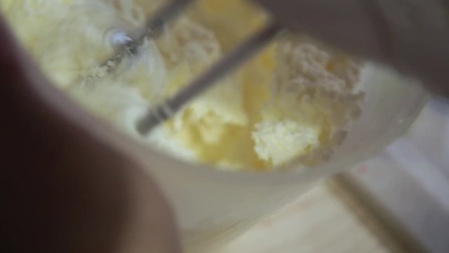 Making red velvet cake at home. Whipping cream mixer