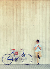people, communication, technology, leisure and lifestyle - hipster man with smartphone and fixed gear bike on city street