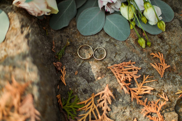 wedding rings on a background of flowers