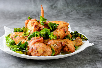 Fried crispy chicken wings with herbs