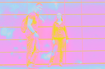 guy with backpack on his back next to girl against wall. psychedelic style